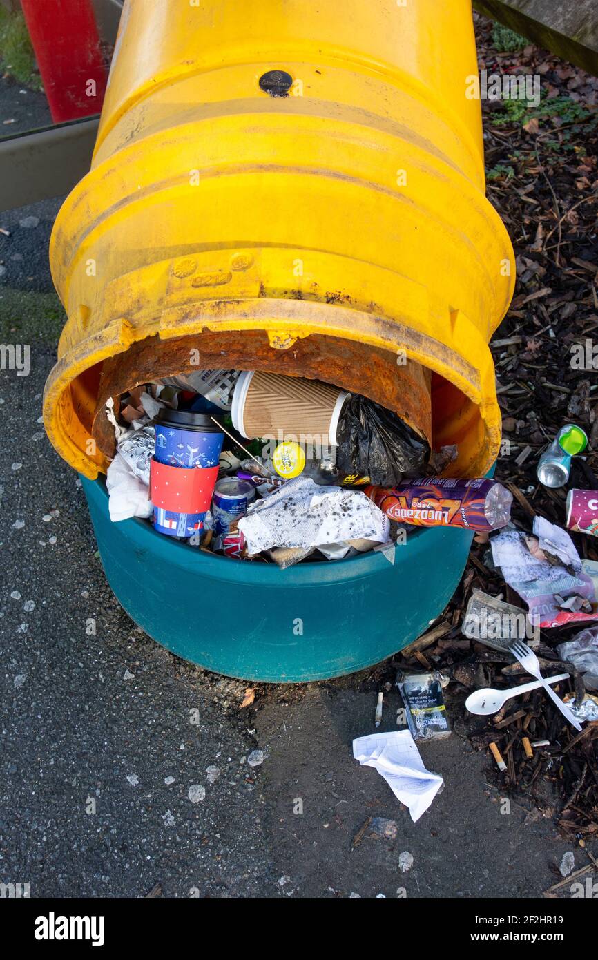 Yellow vandalised overflowing council rubbish bin, Chislehurst South