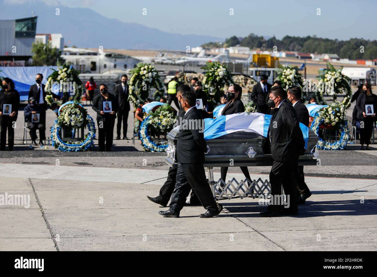 People carry a coffin as relatives of Guatemalan migrants, who were killed  in the Mexican state of Tamaulipas while trying to reach the U.S., attend a  funeral ceremony during the repatriation of