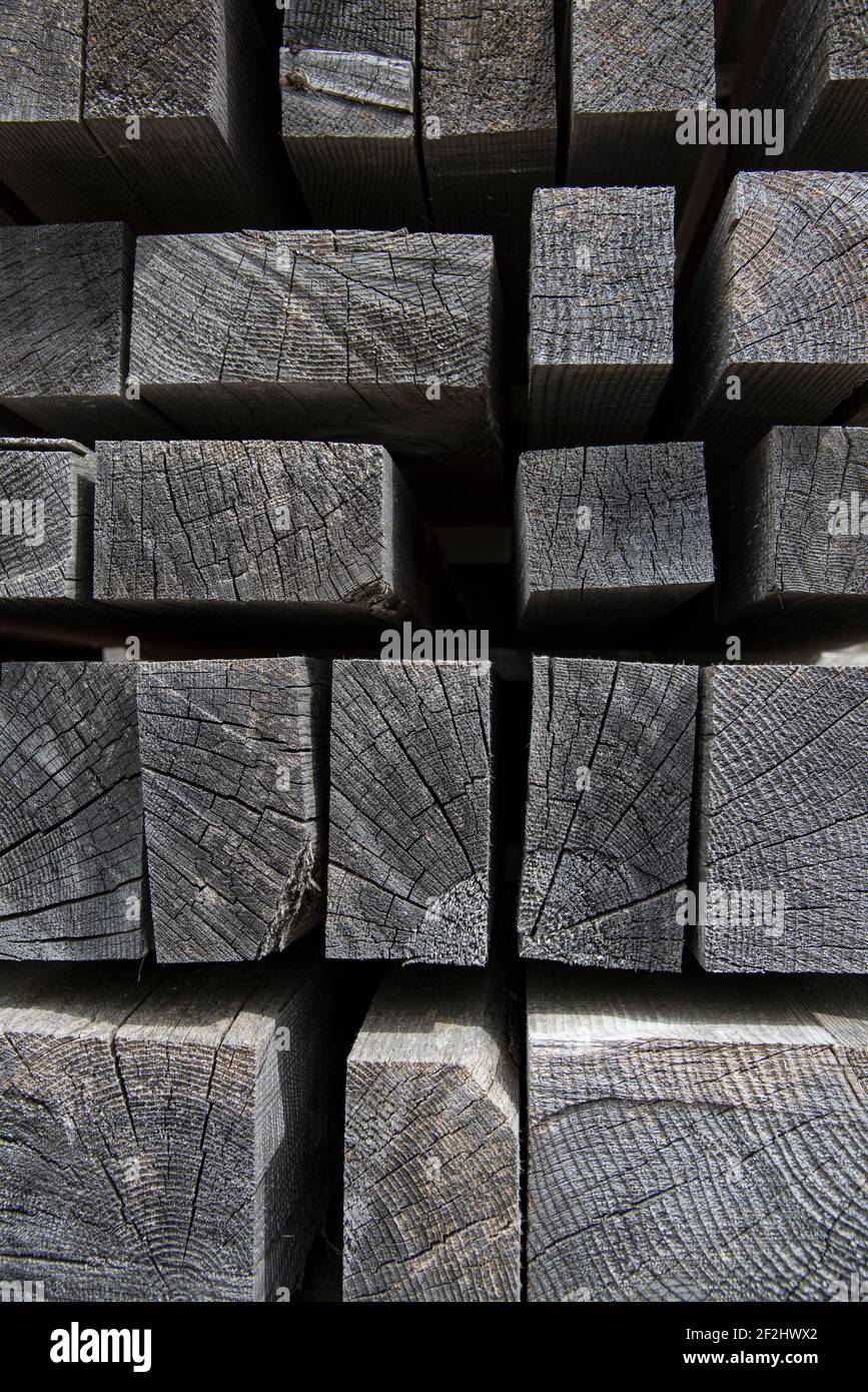 Faded, stacked wooden slats against a black background Stock Photo