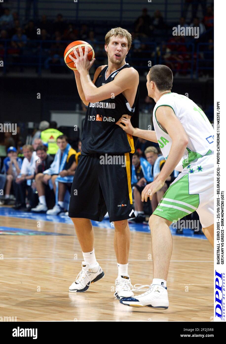 dpa) - German basketball star Dirk Nowitzki warms up ahead of the  basketball match Germany vs USA in Cologne, Germany, 4 August 2004. The  Olympic 'Dream Team' from the United States closely