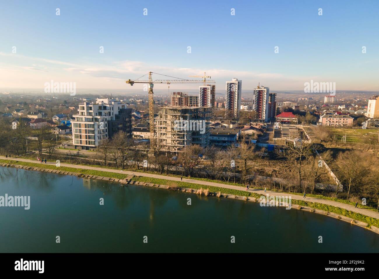 Aerial view of high tower crane and residential apartment buildings ...