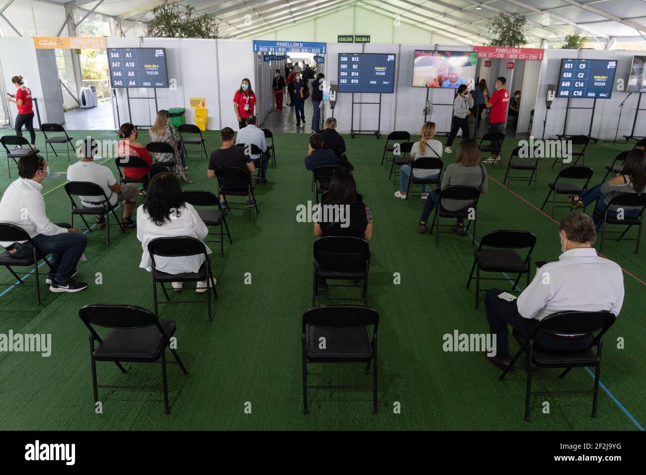 Santiago, Metropolitana, Chile. 12th Mar, 2021. People waiting to be called to receive the Sinovac vaccine against the coronavirus, in a vaccination center set up in a park in Santiago. Credit: Matias Basualdo/ZUMA Wire/Alamy Live News Stock Photo