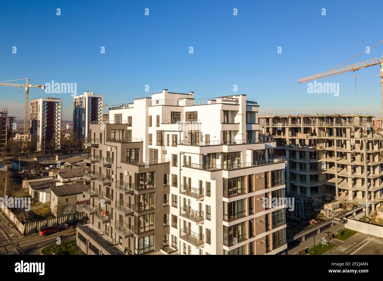 Aerial view of high tower crane and residential apartment buildings ...