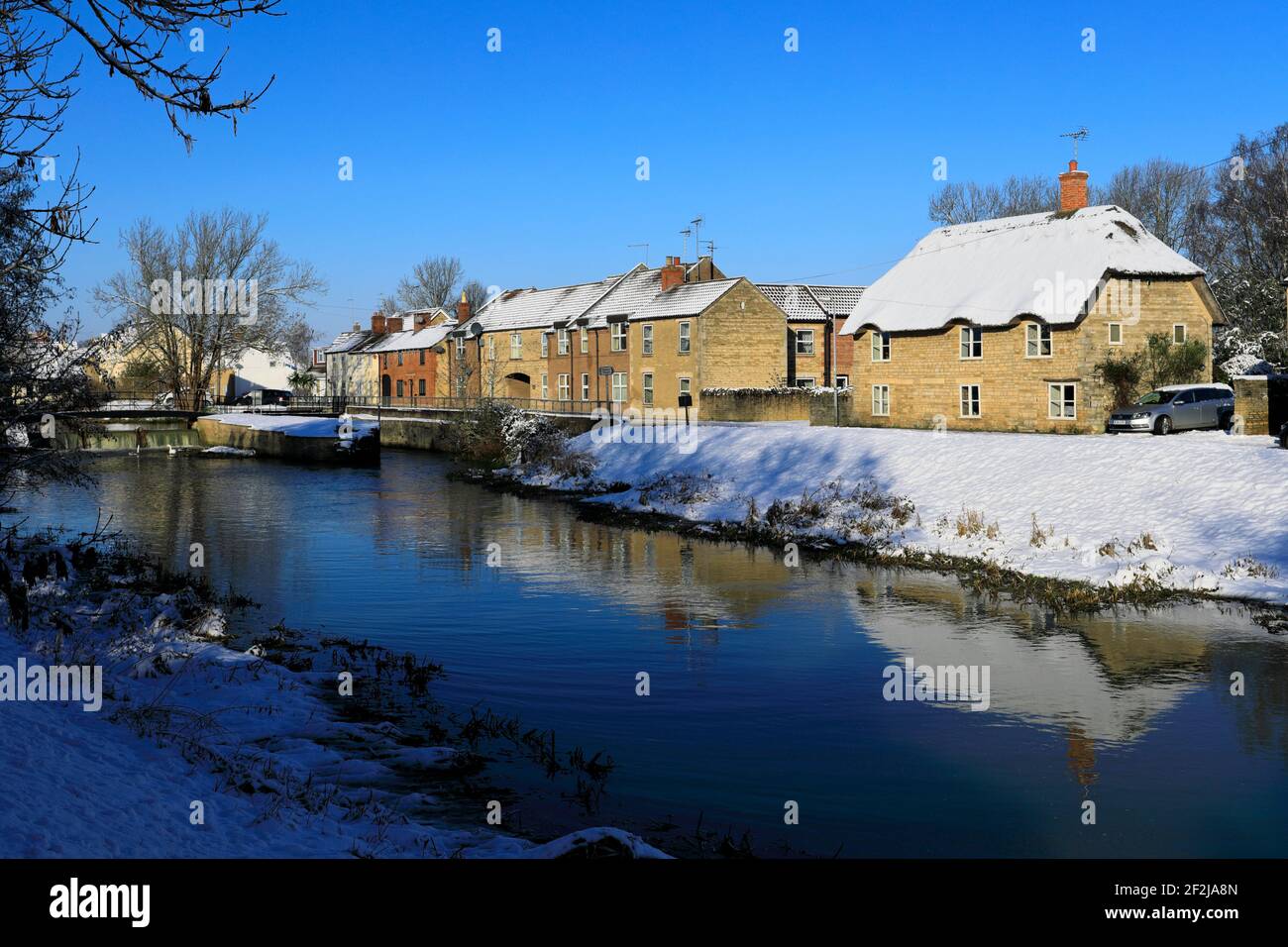 Winter snow over houses on the river Welland, Deeping St James town