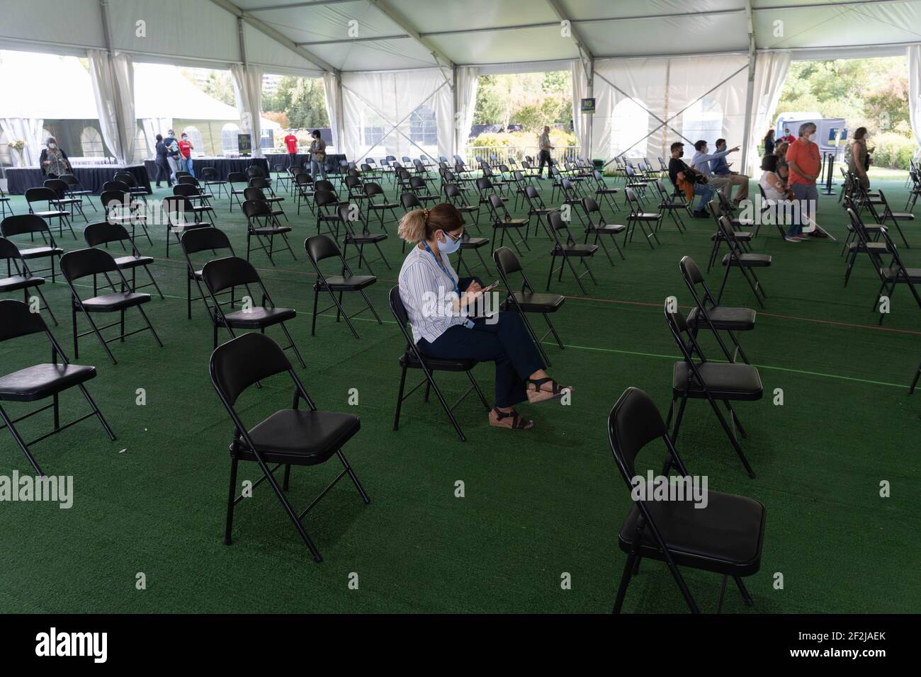 Santiago, Metropolitana, Chile. 12th Mar, 2021. A woman waiting to be called to receive the Sinovac vaccine against the coronavirus, at a vaccination center installed in a park in Santiago. Credit: Matias Basualdo/ZUMA Wire/Alamy Live News Stock Photo