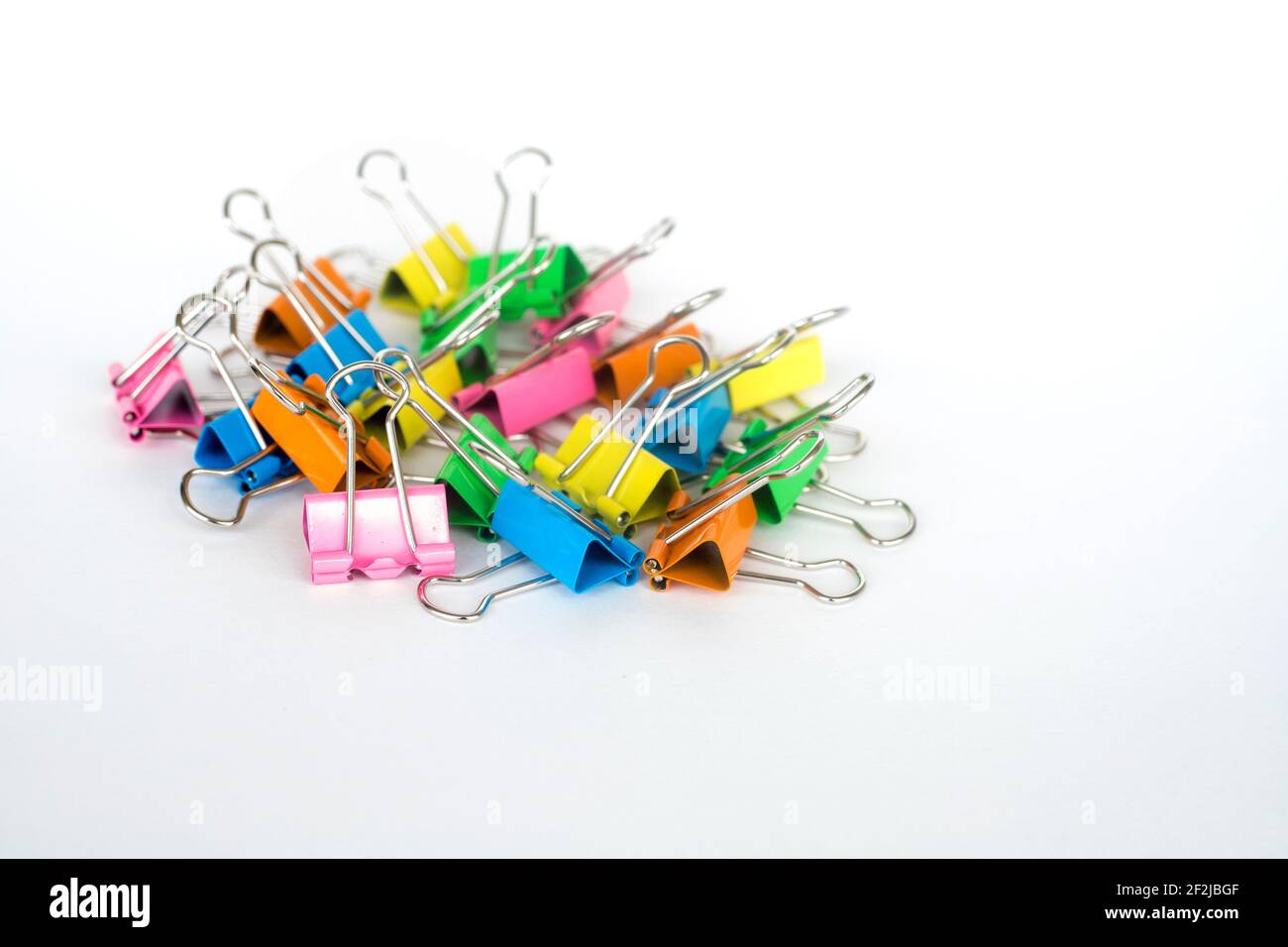 Multi color paper binder clips on white background Stock Photo