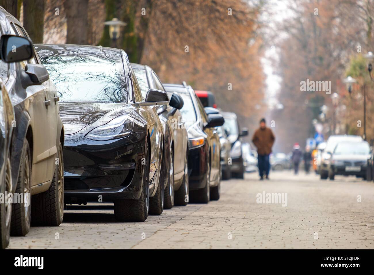 Cars parked in a row on a city street side Stock Photo - Alamy