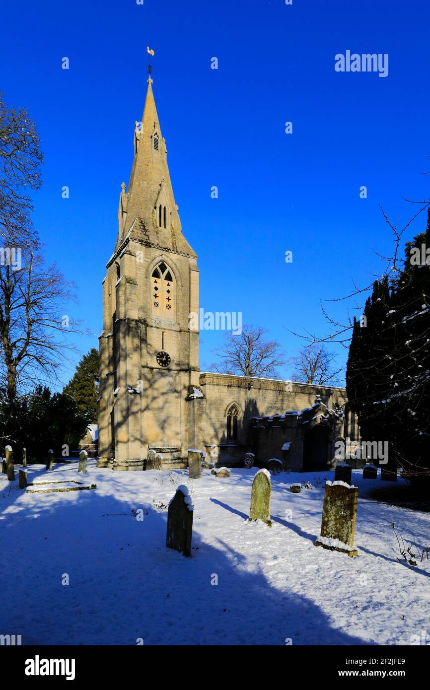 Winter snow over St Marys church, Bainton village, Cambridgeshire England UK Stock Photo