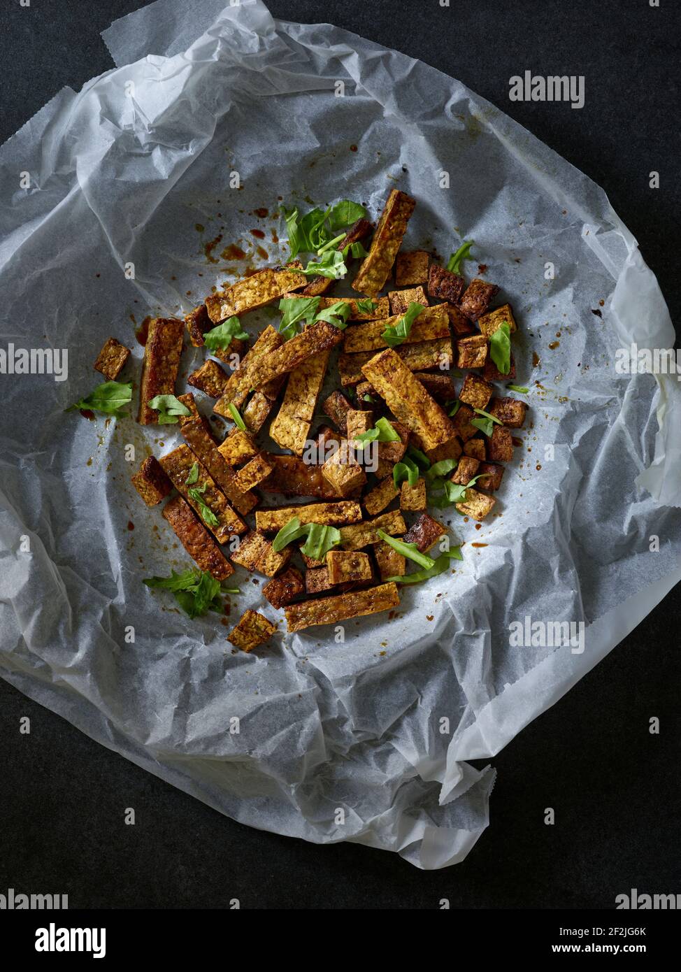 Supervision of Ayurvedic tofu sticks in baking paper, roasted in the oven Stock Photo Alamy