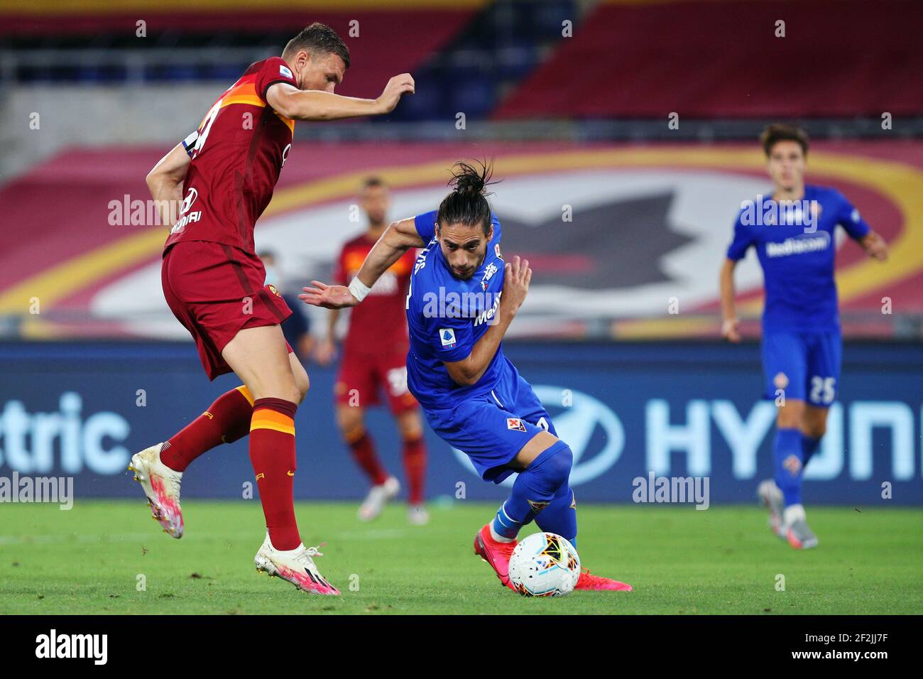 Edin Dzeko of Roma (L) vies for the ball with Martin Caceres of Fiorentina (R) during the Italian championship Serie A football match between AS Roma and ACF Fiorentina on July 26, 2020 at Stadio Olimpico in Rome, Italy - Photo Federico Proietti / DPPI Stock Photo