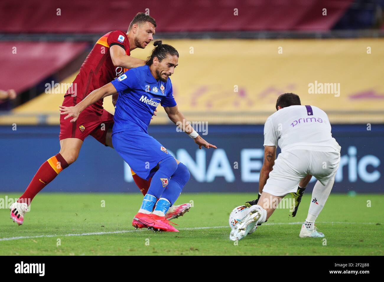Edin Dzeko of Roma (L) vies for the ball with Martin Caceres (C) of Fiorentina and Fiorentina goalkeeper Pietro Terracciano (R) during the Italian championship Serie A football match between AS Roma and ACF Fiorentina on July 26, 2020 at Stadio Olimpico in Rome, Italy - Photo Federico Proietti / DPPI Stock Photo