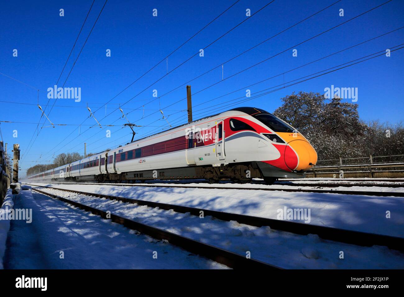 Class 800, LNER Azuma train in snow, East Coast Main Line Railway, Peterborough, Cambridgeshire, England, UK Stock Photo