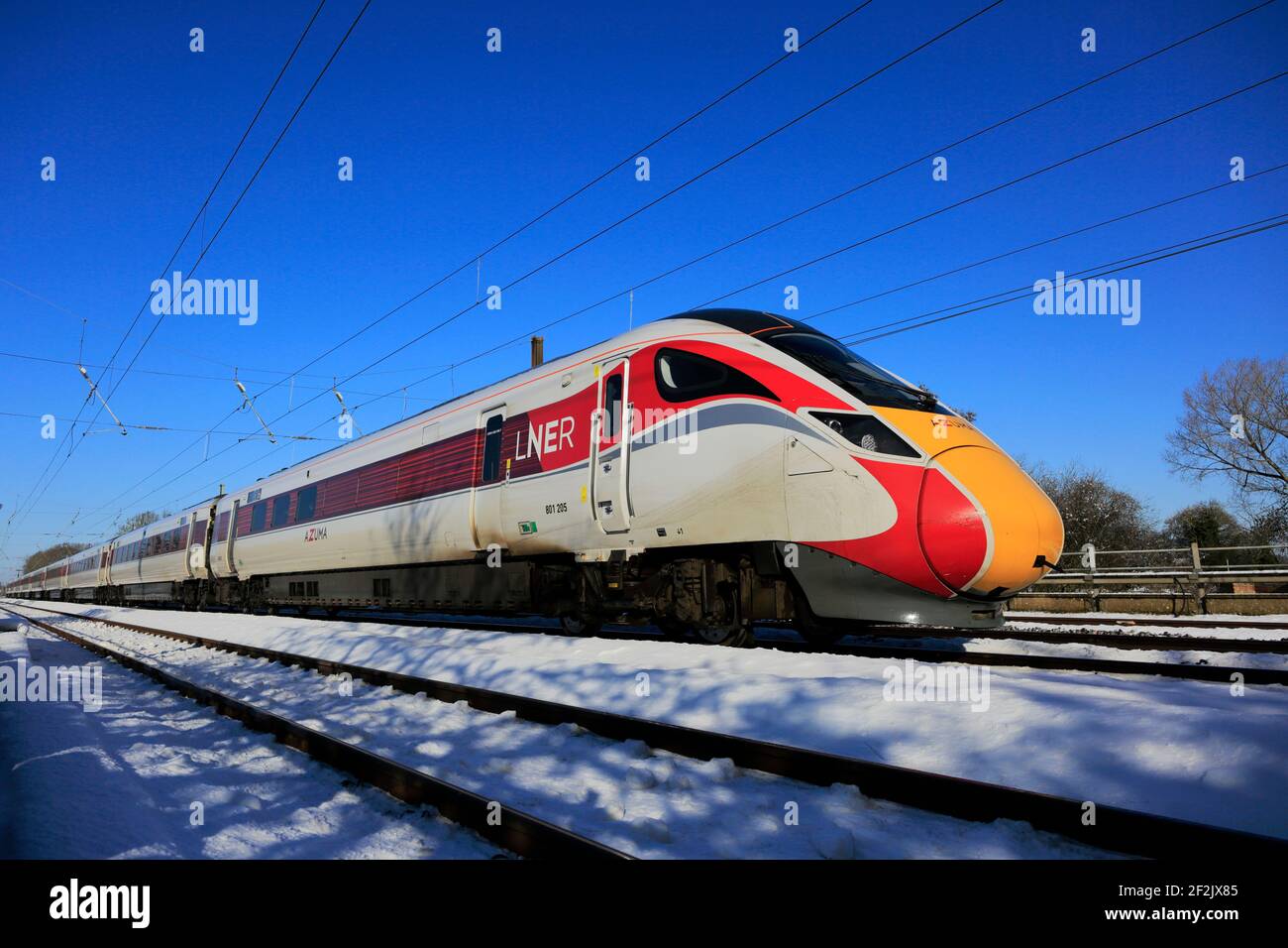 Class 800, LNER Azuma train in snow, East Coast Main Line Railway, Peterborough, Cambridgeshire, England, UK Stock Photo