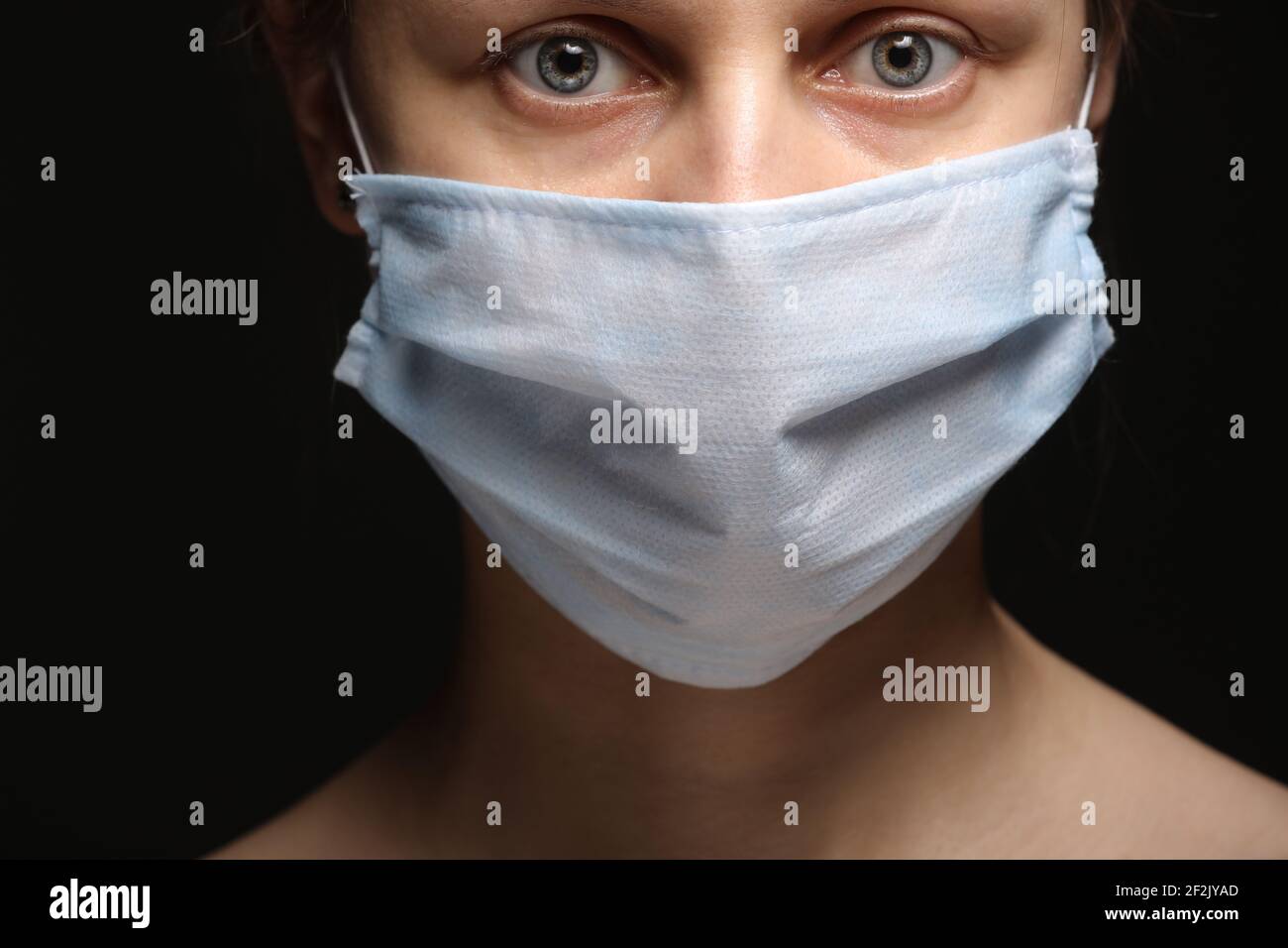 Young woman wearing a protective mask during the Coronavirus disease ...