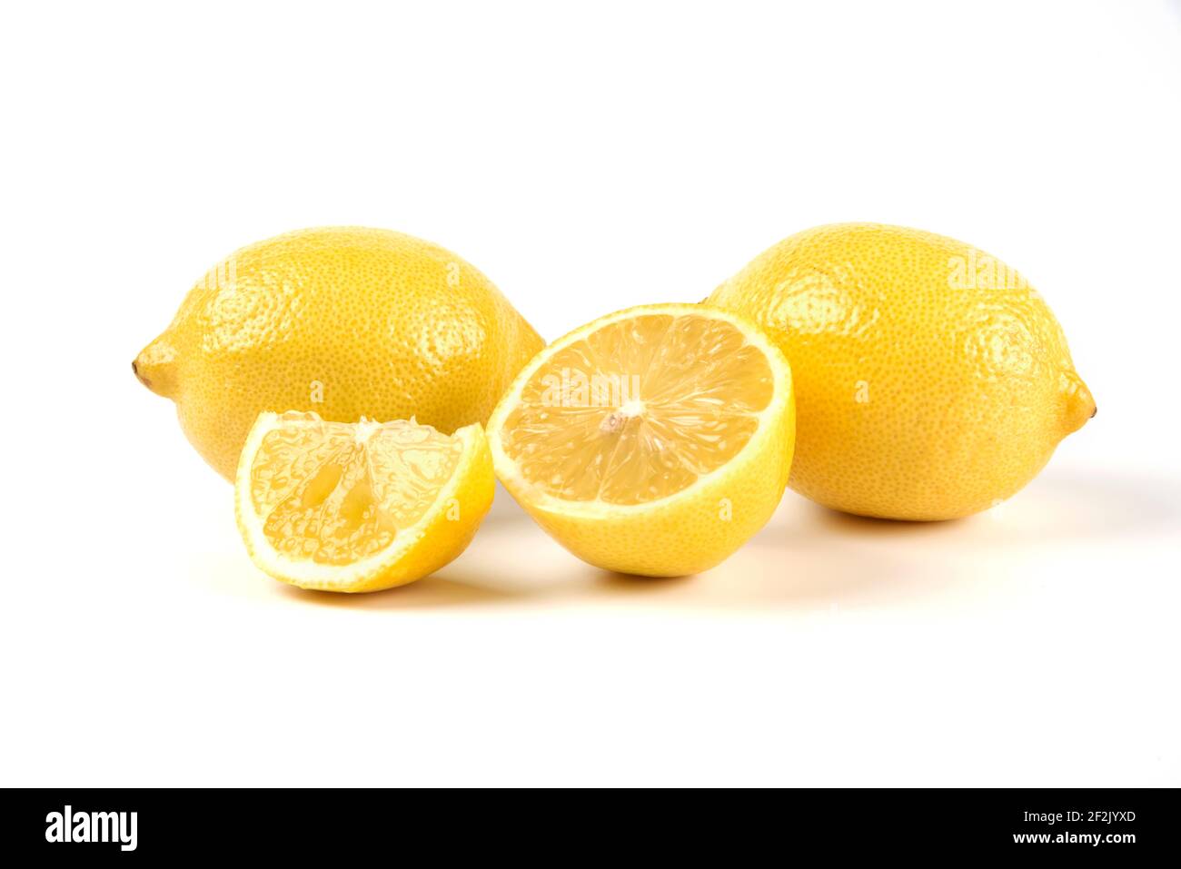 A slice and whole lemons isolated on white background Stock Photo - Alamy