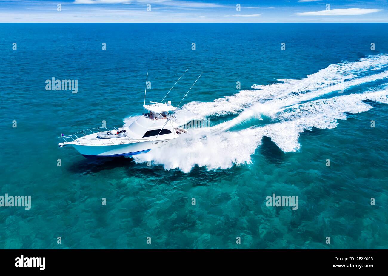 aerial view of boat driving across aqua water in the Bahamas Stock Photo