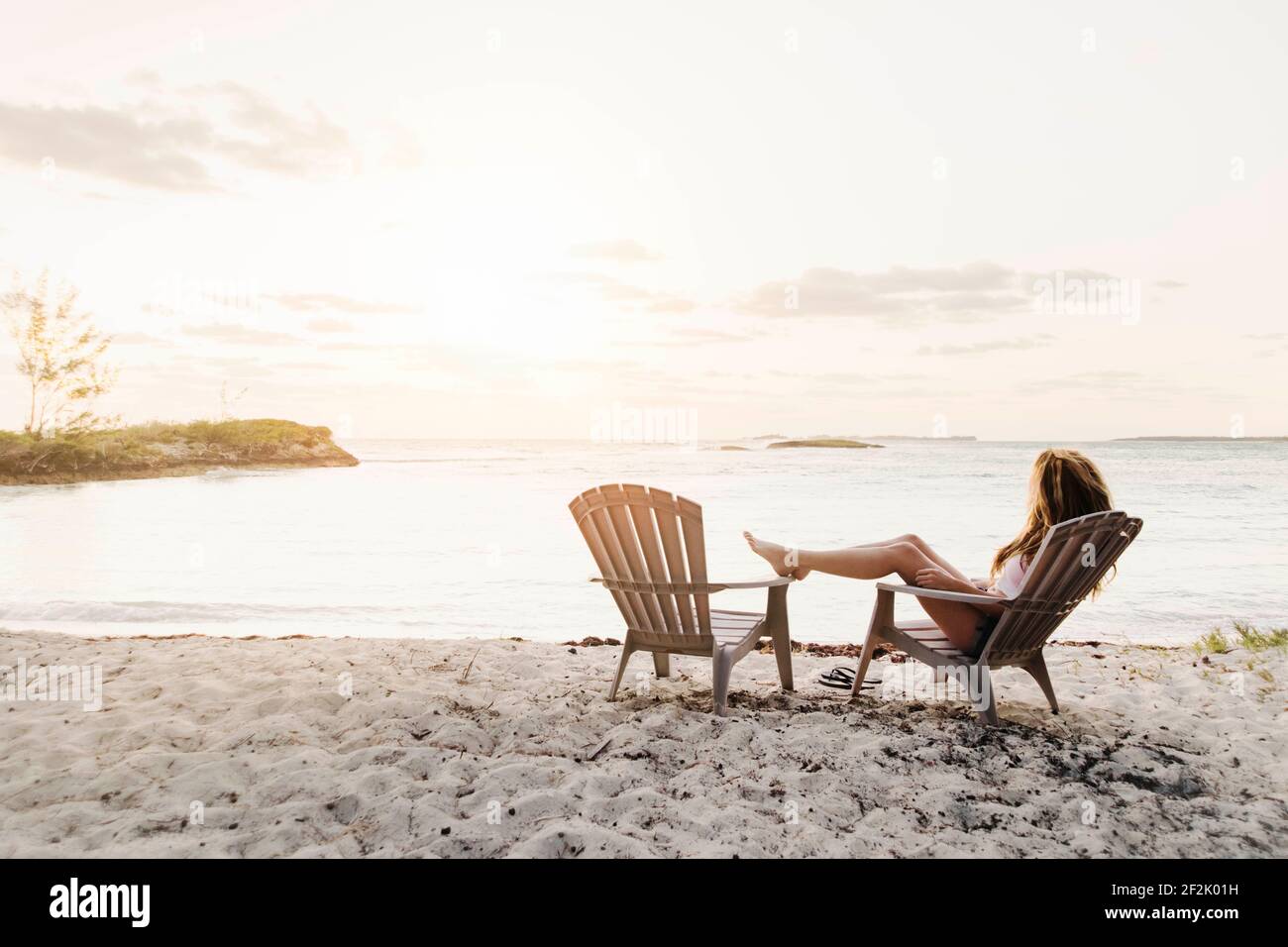 Female sitting on beach hi-res stock photography and images - Alamy