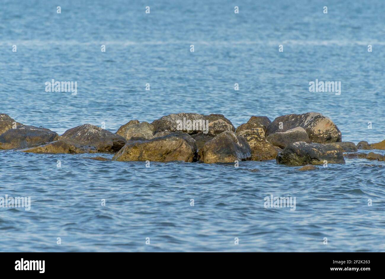 Seascape with rocks emerging from the sea Stock Photo