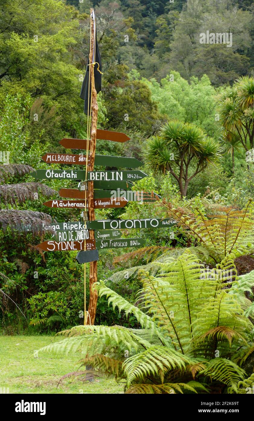 Signpost with international cities seen at the South Island of New Zealand Stock Photo
