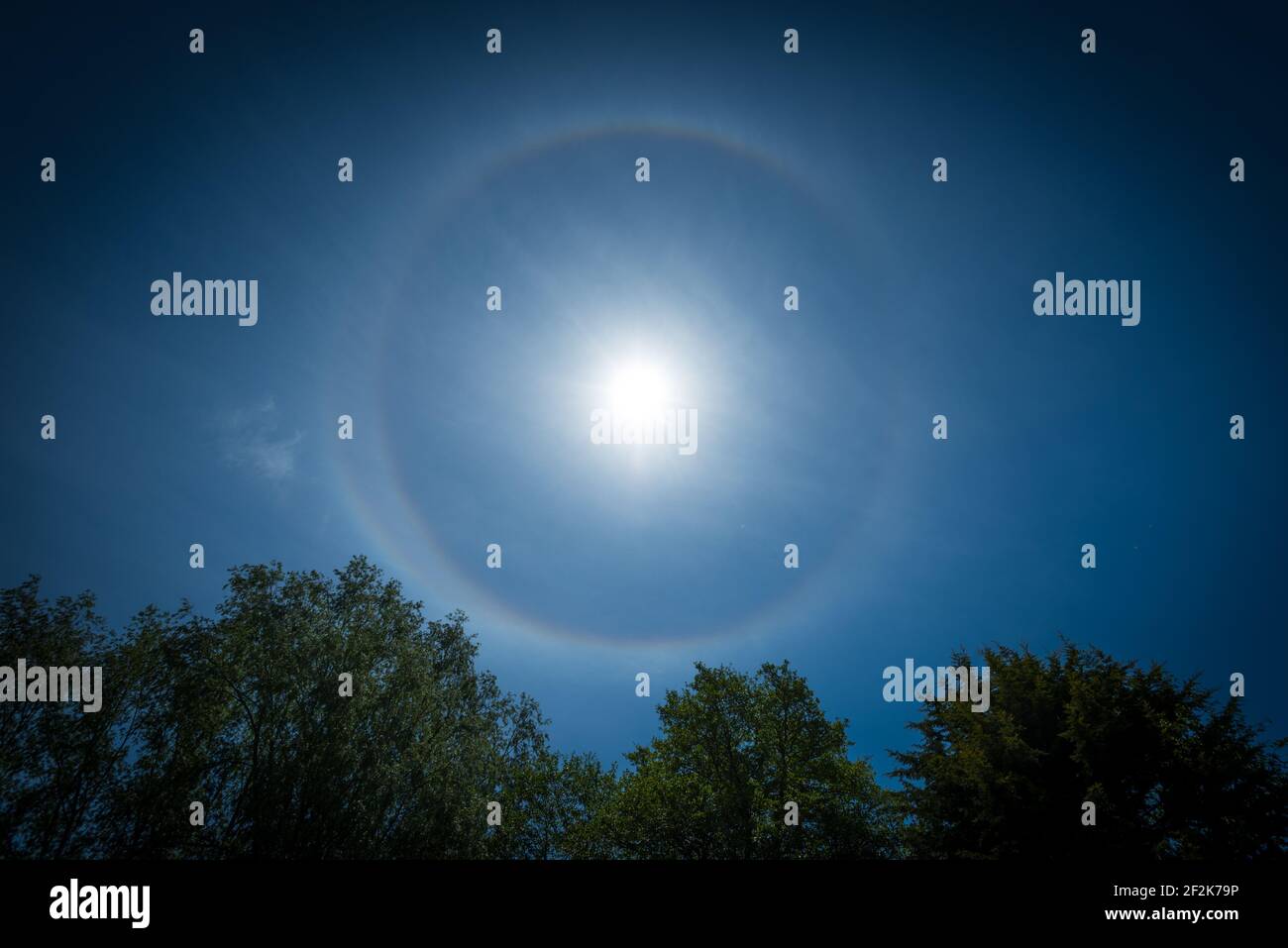 A 22 degree halo around the sun as seen from Exeter, Devon, UK. Stock Photo