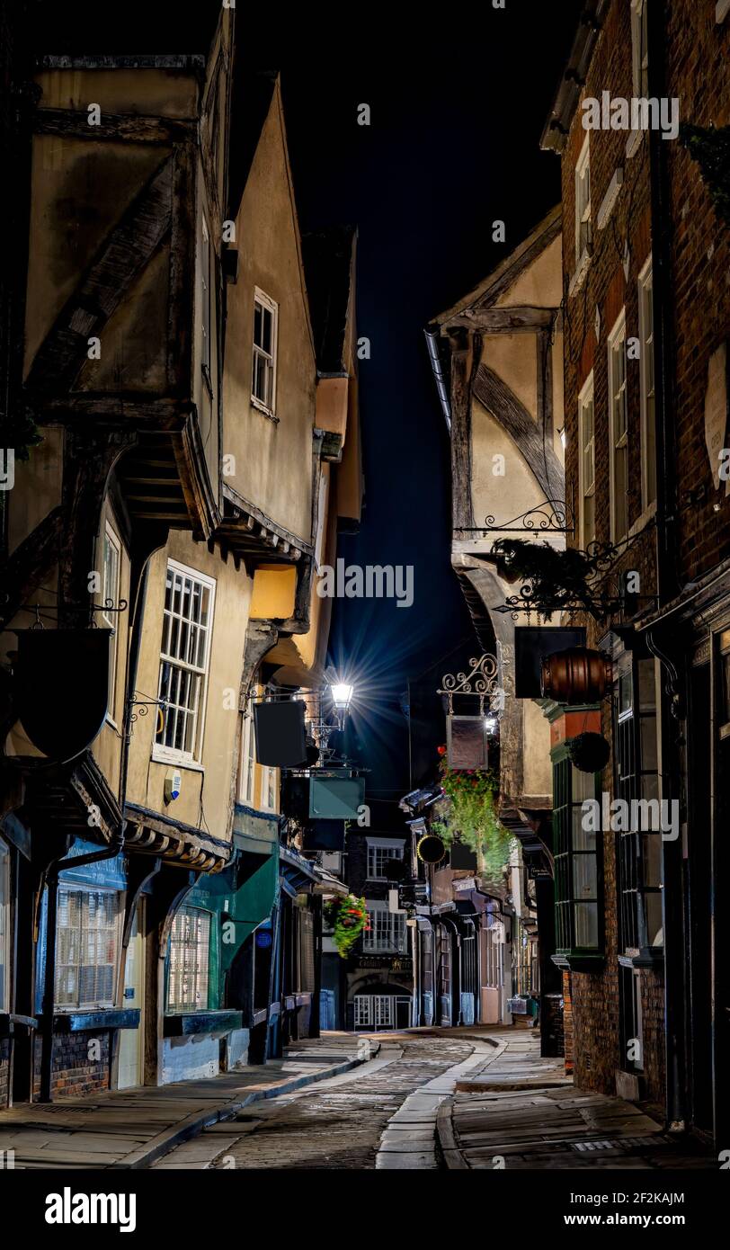 The Shambles in York, England, historic old cobbled street of leaning buildings and shops.Yorkshire, England. Cobbled historic streets Stock Photo