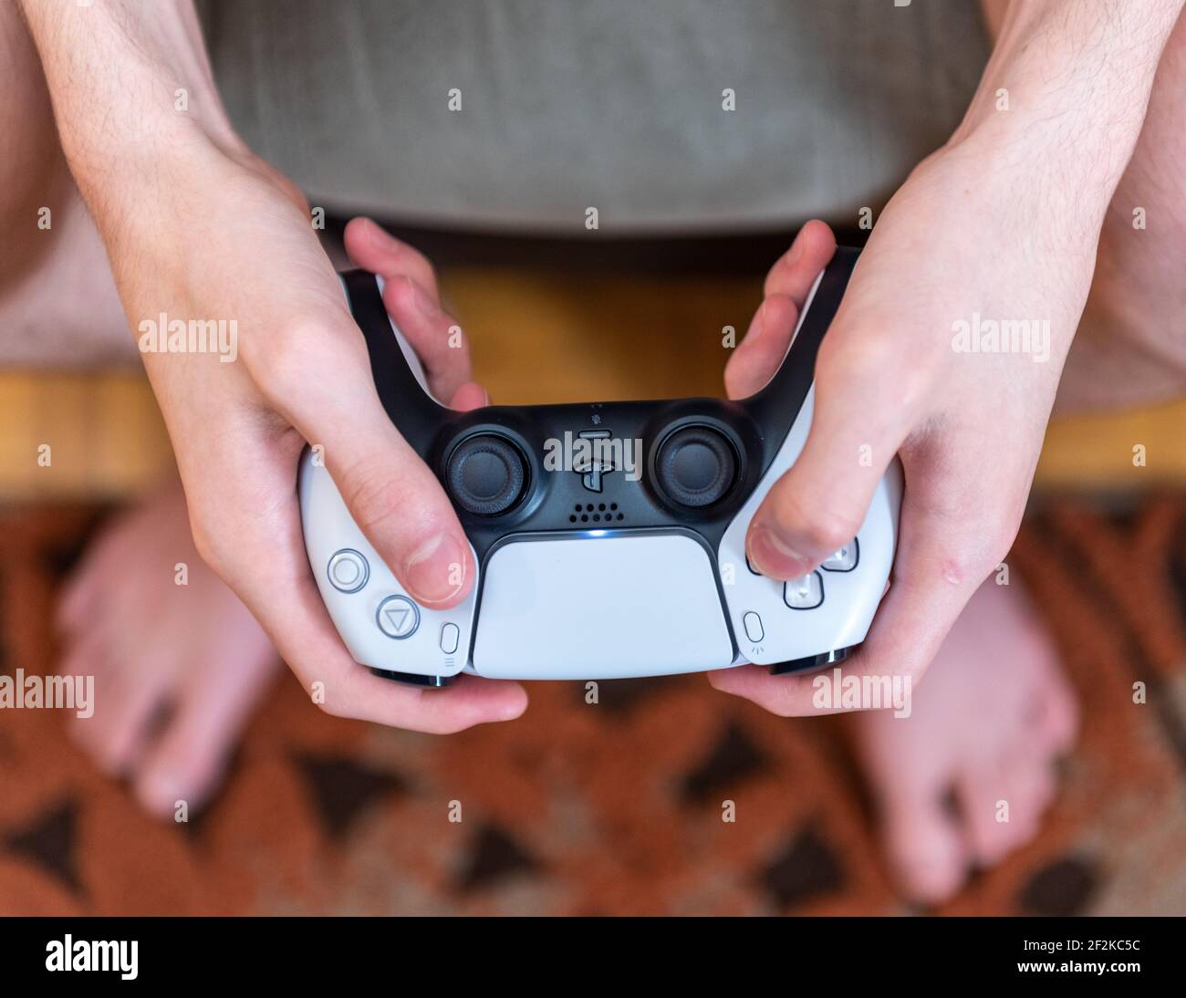 Hands operating a PS5 controller Stock Photo - Alamy