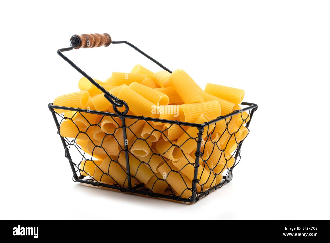 Wicker basket of raw tube pasta isolated on white background Stock Photo