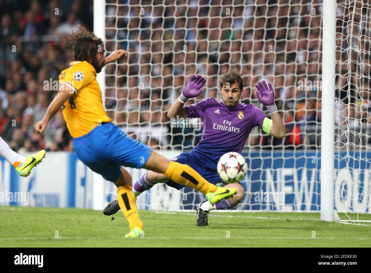 Football - UEFA Champions League 2013/2014 - Group Stage - Group B - Real Madrid v Juventus FC on October 23, 2013 in Madrid , Spain - Photo Manuel Blondeau / AOP PRESS / DPPI - Iker Casillas of Real Madrid makes a save under pressure from Andrea Pierlo of Juventus Stock Photo