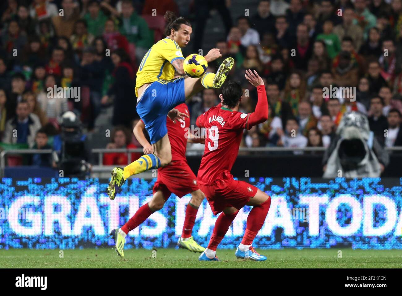 Football - FIFA World Cup 2014 - Qualifiying - Play Offs - 1st Leg - Portugal v Sweden on November 15, 2013 in Lisbon , Portugal - Photo Manuel Blondeau / AOP PRESS / DPPI - Zlatan Ibrahimovic of Sweden jumps to control the ball under pressure from Hugo Almeida of Portugal Stock Photo