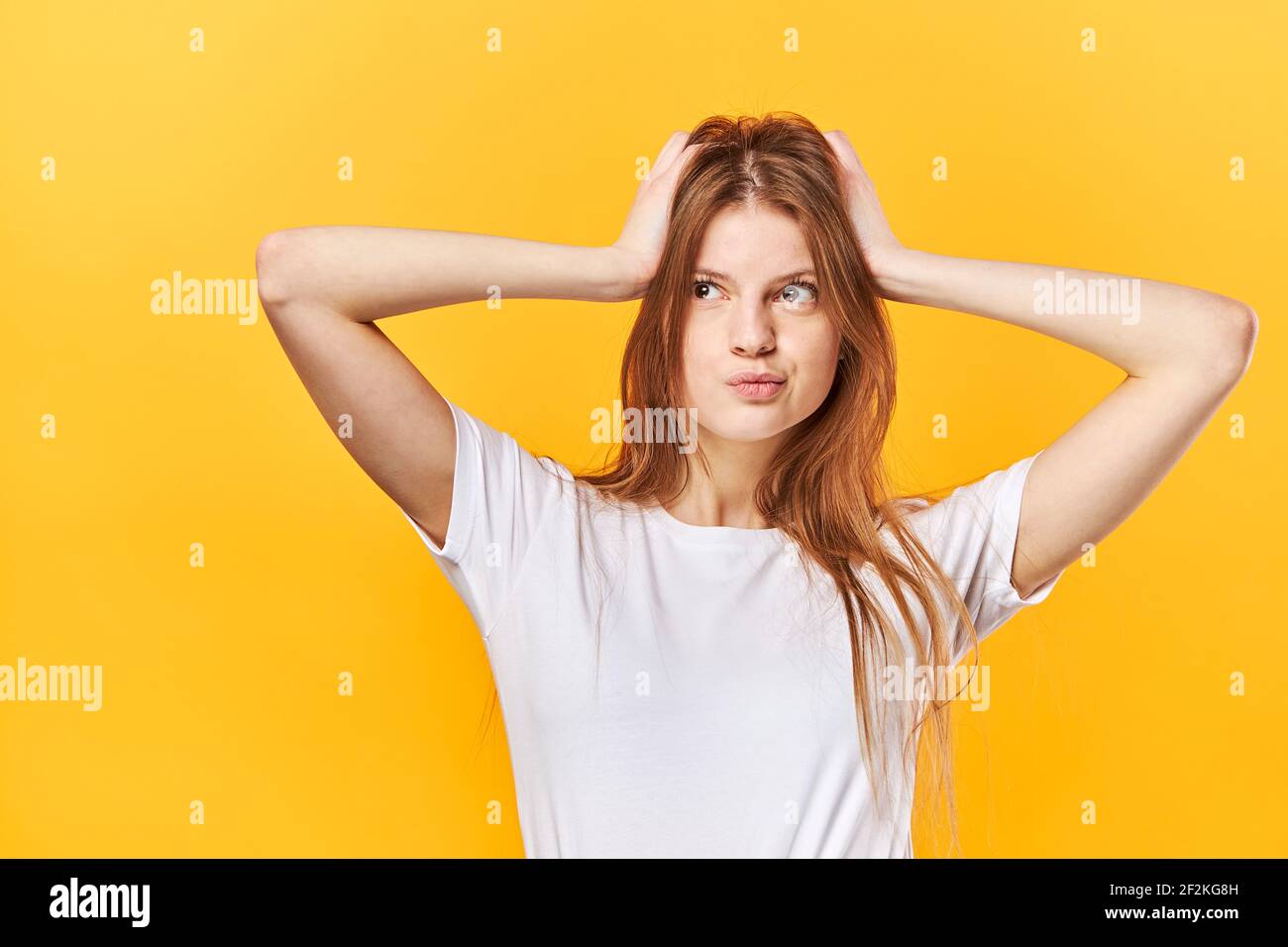 Portrait of shocked scared girl having panic holding two palms Stock Photo