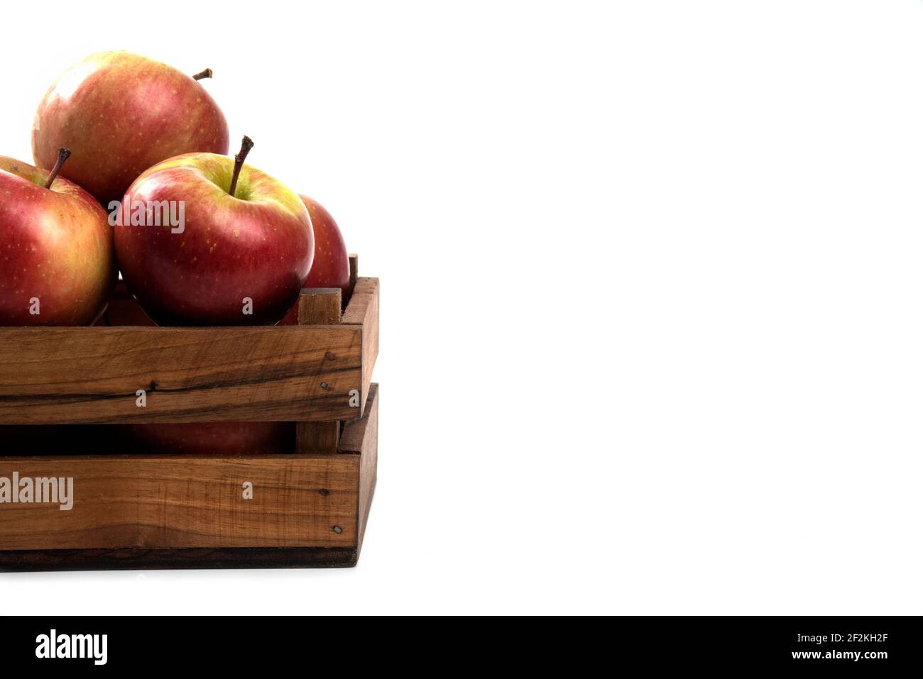 Fresh apples in a wooden crate isolated on white background Stock Photo