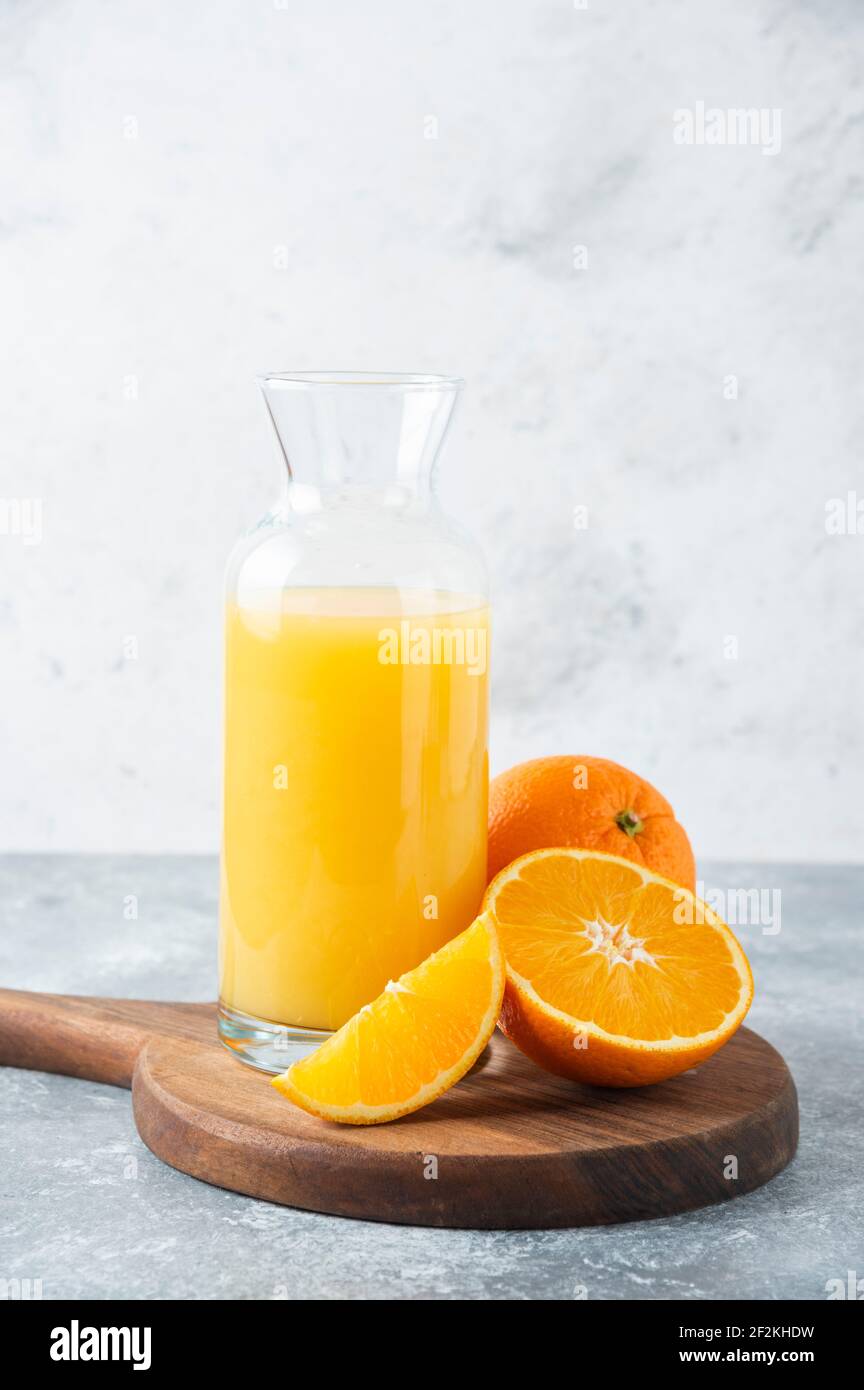 Glass pitcher of juice with slice of orange fruit Stock Photo