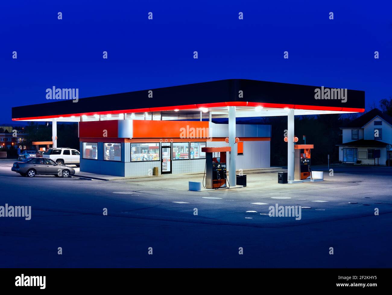 Horizontal shot of a generic gasoline station and convenience store at dusk. Stock Photo