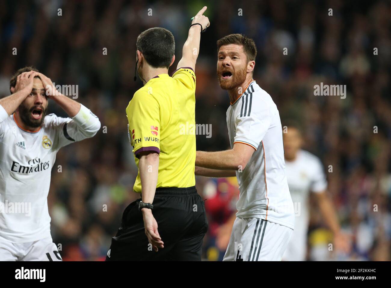 Football - Spanish Championship 2013/2014 - Liga - Real Madrid v FC Barcelona on March 23, 2014 in Bernabeu Stadium of Madrid , Spain - Photo Manuel Blondeau / AOP PRESS / DPPI - Daniel Carvajal (L) and Xabi Alonso of Real Madrid react as Referee Alberto Undiano Mallenco awards a penalty Stock Photo