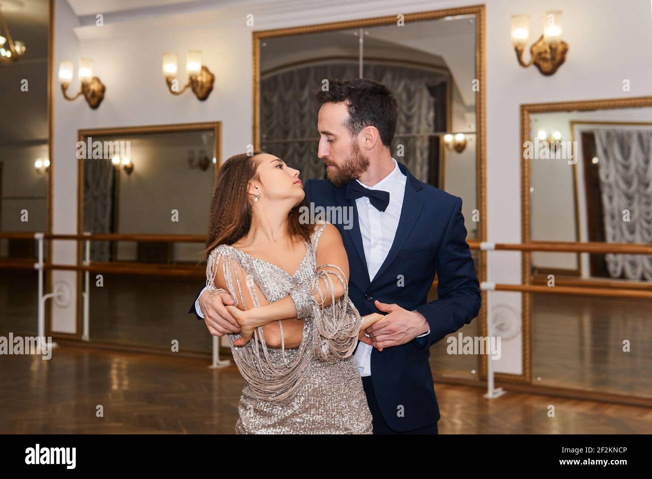 man and woman dancing and look at each other in a vintage hall with mirrors Stock Photo Alamy
