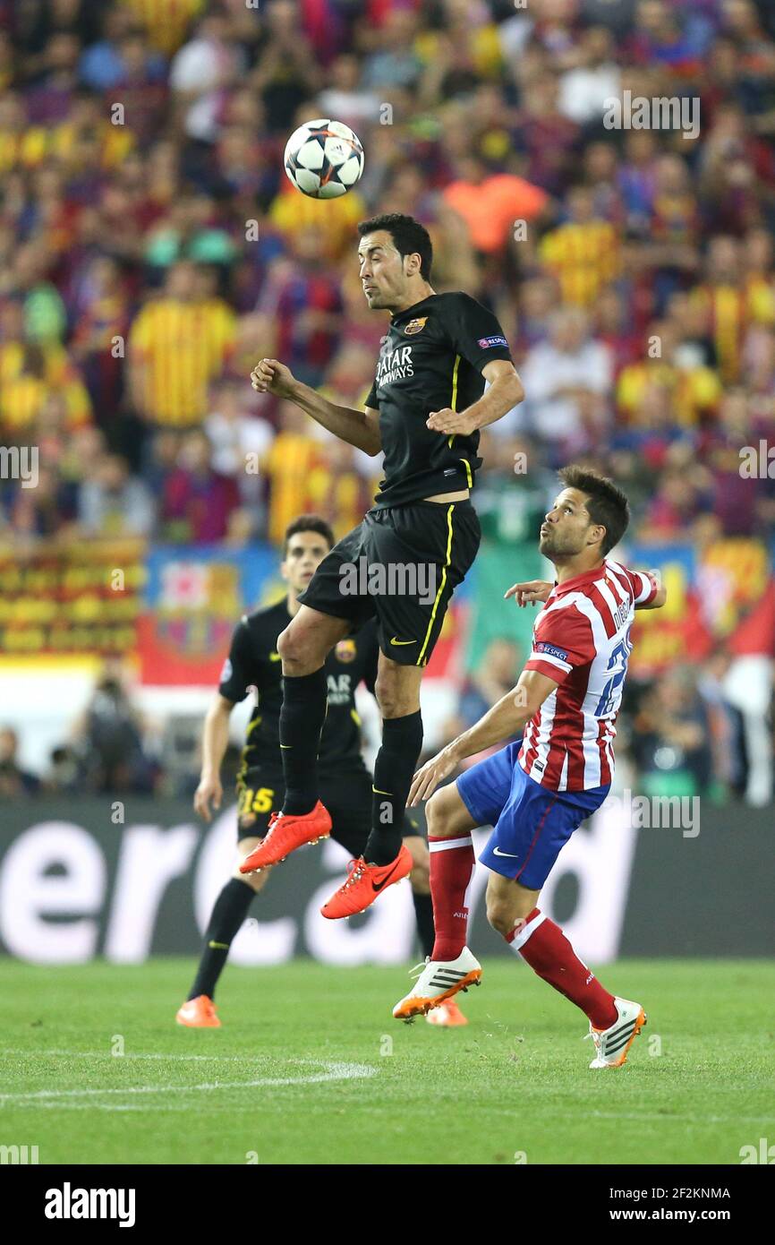 Sergio Busquets of FC Barcelona jumps to head the ball under pressure from Diego Ribas of Atletico de Madrid during the UEFA Champions League 2013/2014 football match 1/4 Final , 2nd Leg between Atletico Madrid and FC Barcelona on April 9, 2014 at Vicente Calderon stadium in Madrid, France. Photo Manuel Blondeau / AOP PRESS/ DPPI - Stock Photo