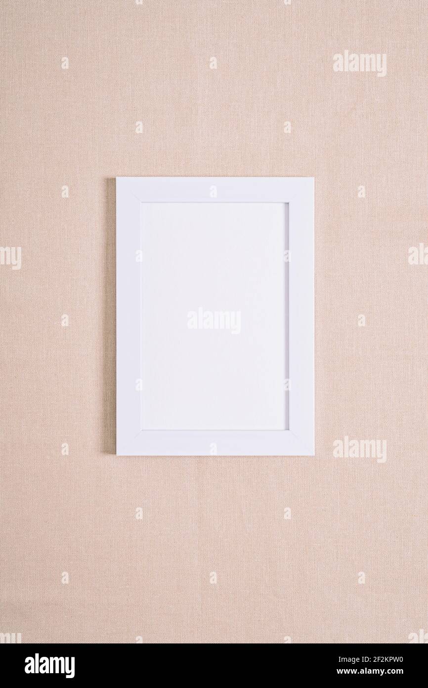 White picture frame mockup on a beige textile Stock Photo