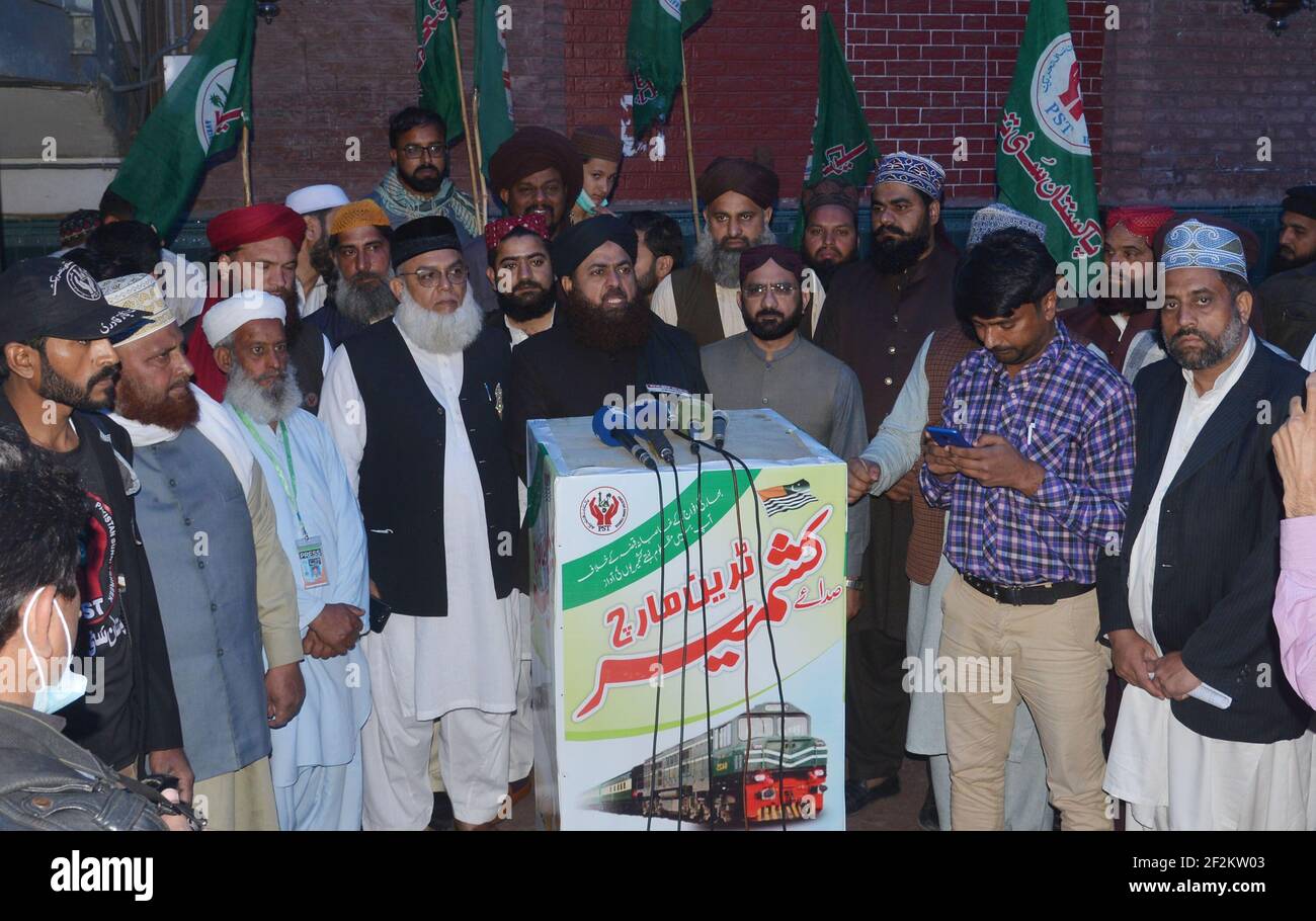 Lahore, Pakistan. 12th Mar, 2021. Pakistan Sunni Tehreek (PST) workers  arrived at the railway station and fixing banner outside the train during  PST's Lahore to Karachi “Sada-e-Kashmir Train March” Central Leader of