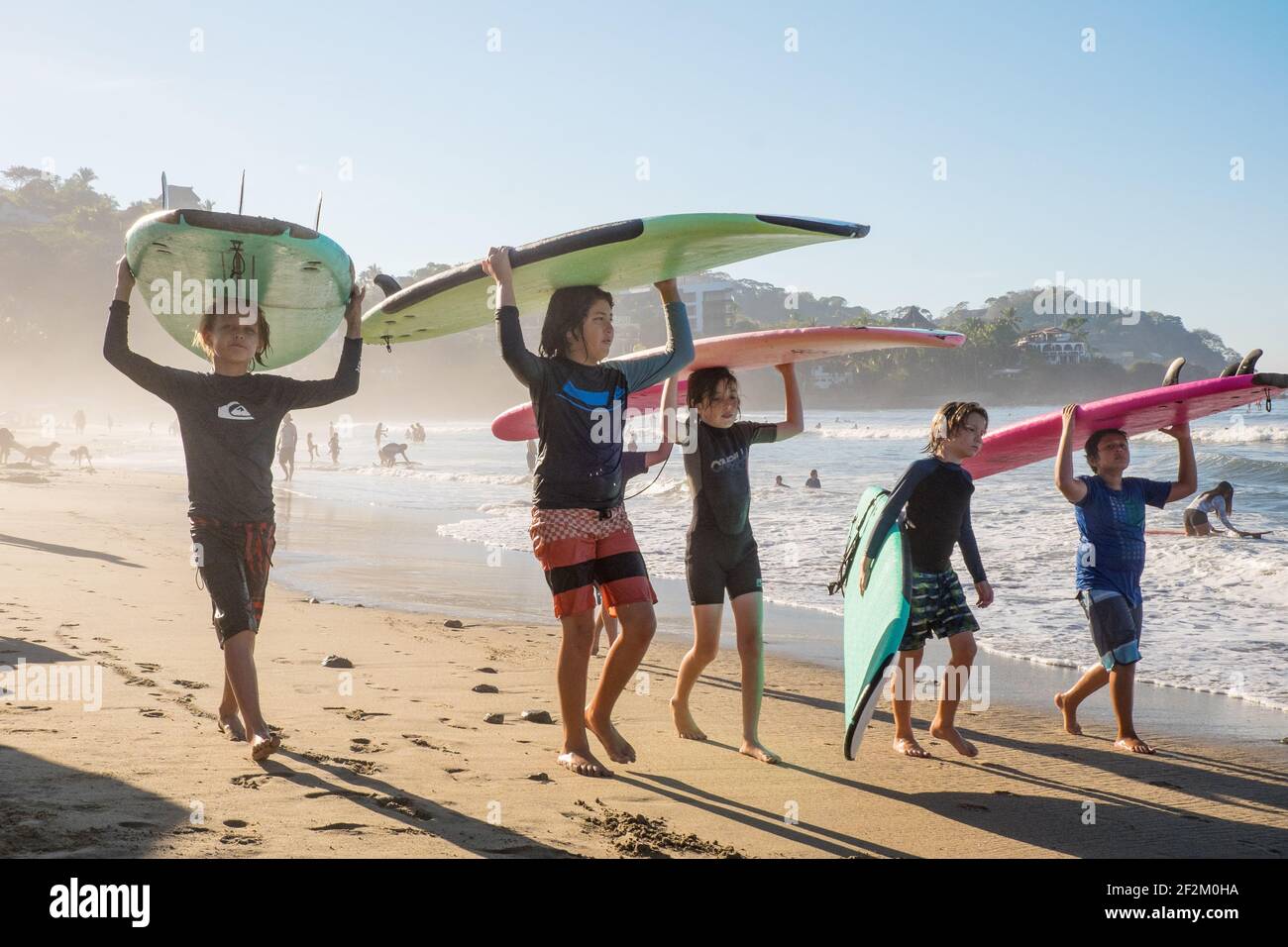 Children surfing on the beach in Sayulita, Mexico Stock Photo