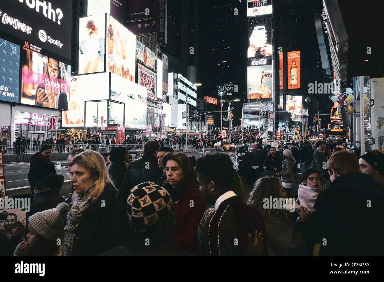 Illuminated Time Square at Night with Crowded people in New York, Broadway and Seventh Street Stock Photo