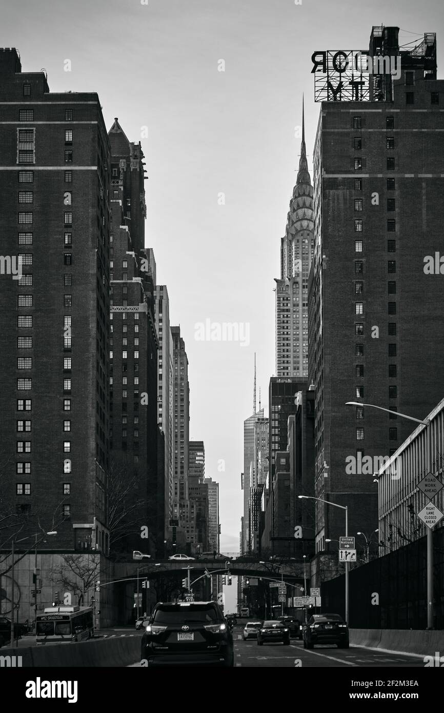 Brickwall Buildings and Skyscraper Chrysler Buillding in New York City, USA, Untited States of America, Black and White Stock Photo