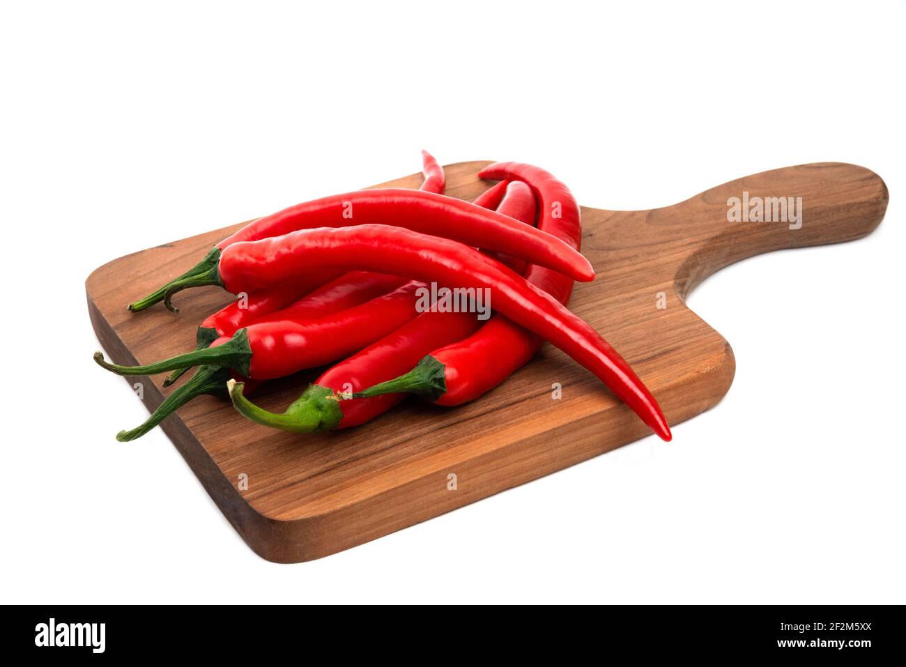 Wooden board of red chili peppers isolated on white background Stock ...