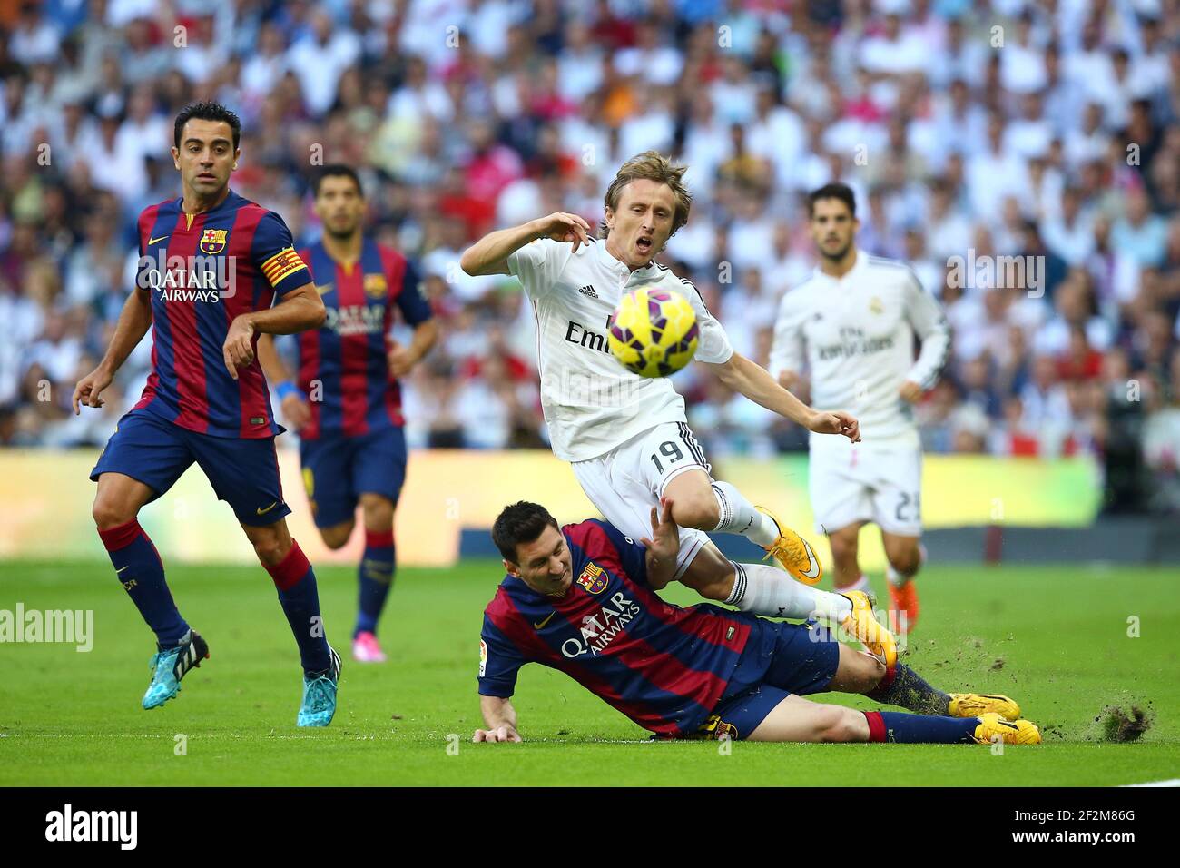 Luka Modric of Real Madrid is tackled by Lionel Messi of FC Barcelona during the Spanish Championship Liga football match between Real Madrid CF and FC Barcelona, at Santiago Bernabeu Stadium in Madrid, Spain, on October 25, 2014. Photo Manuel Blondeau / AOP.press / DPPI Stock Photo