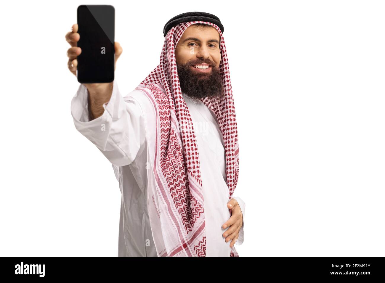 Smiling saudi arab man showing a mobile phone isolated on white background Stock Photo