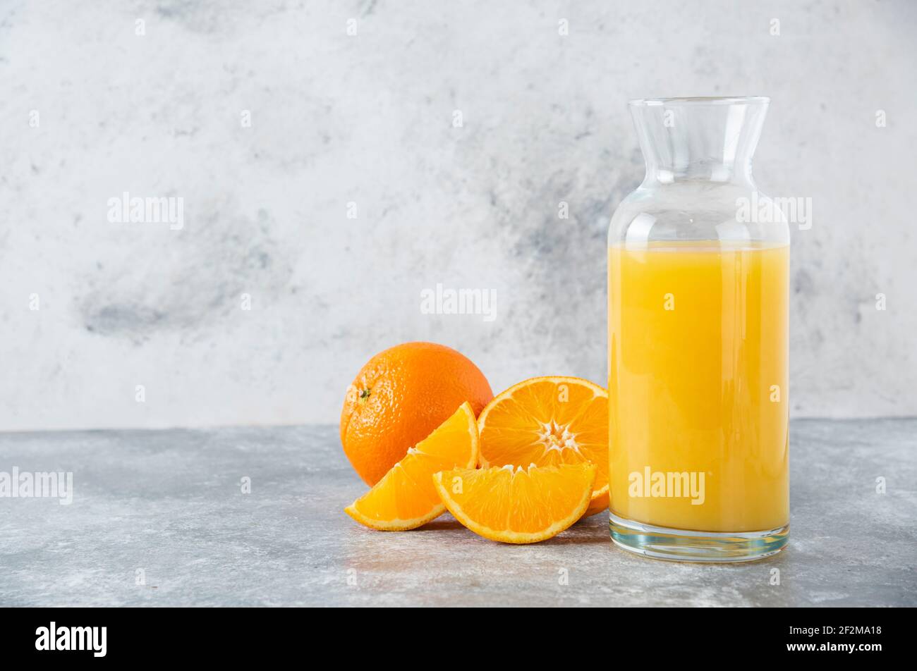 https://c8.alamy.com/comp/2F2MA18/glass-pitcher-of-juice-with-slice-of-orange-fruit-2F2MA18.jpg