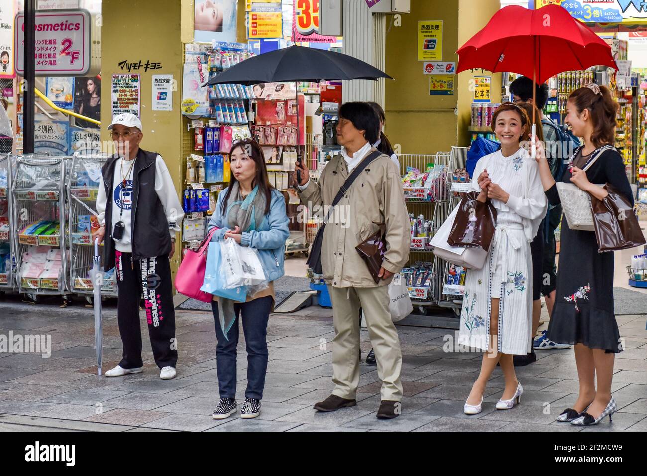 Japanese pedestrians waiting to cross a street, Kyoto, Japan Stock Photo