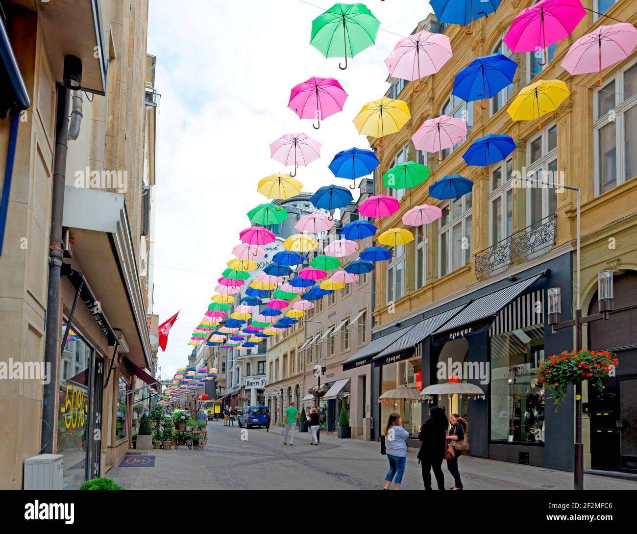 Colorful umbrellas hanging between the houses in a pedestrian zone, Luxembourg, Luxembourg City Stock Photo