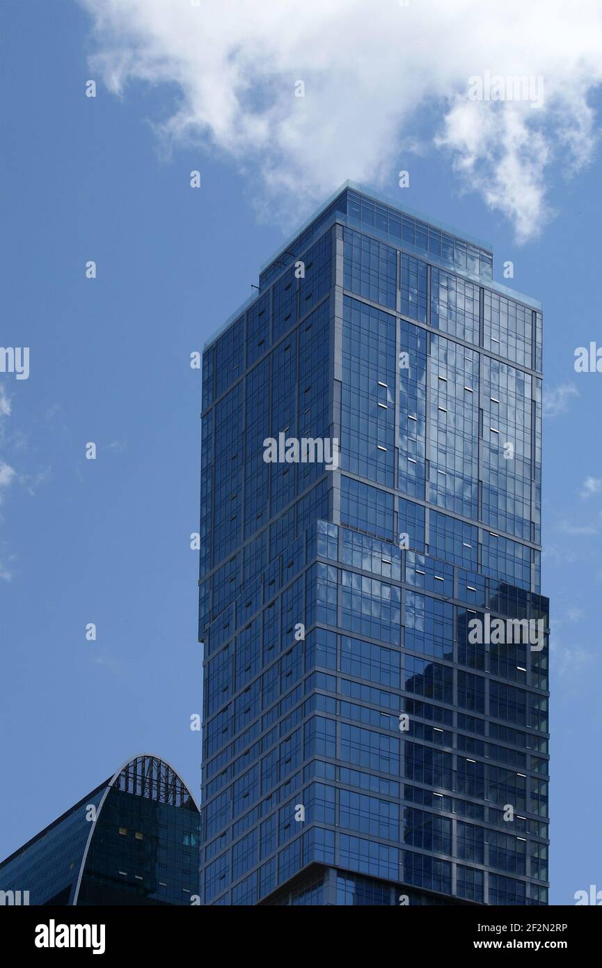 Reflection of a cloudy sky in glass wall of an office building Stock ...