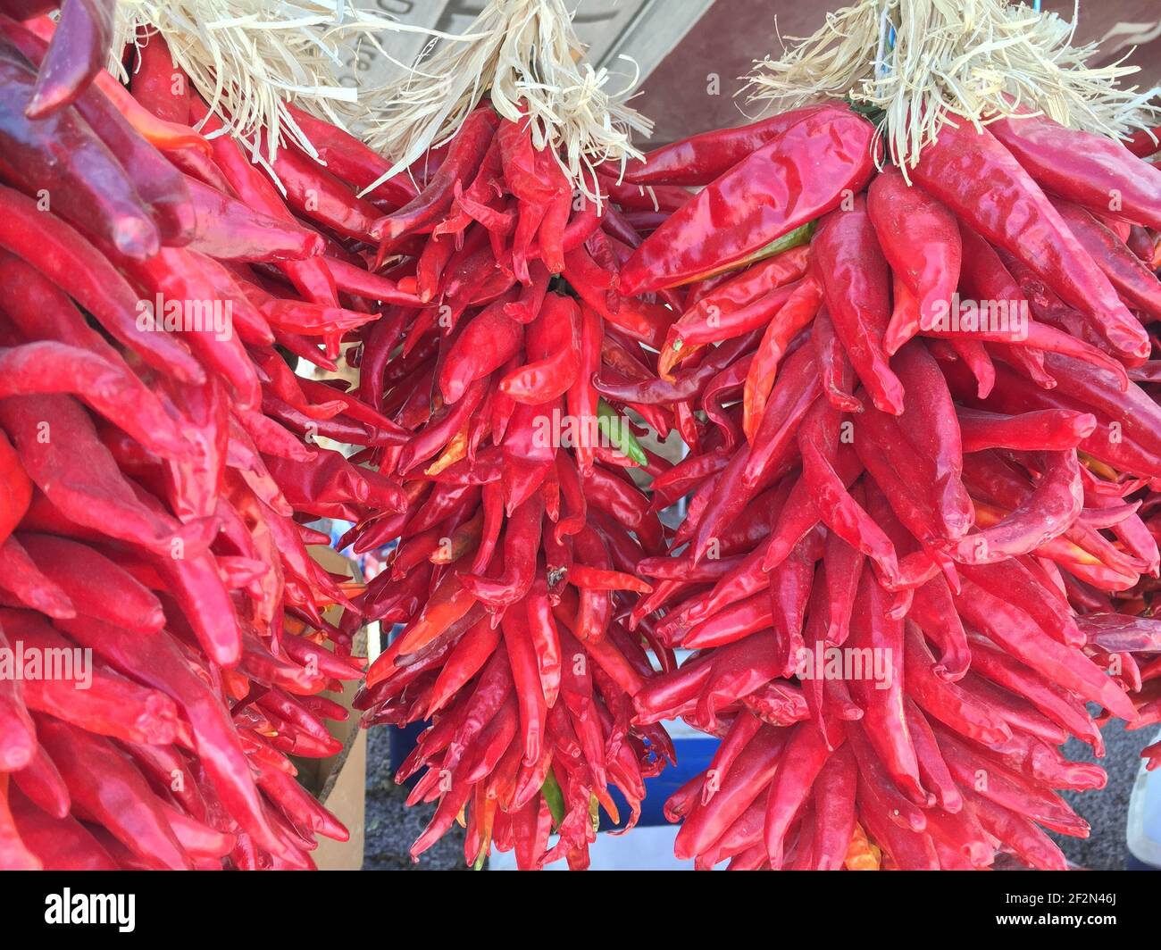 A closeup of bunches of red hot chili peppers hanging to dry Stock ...