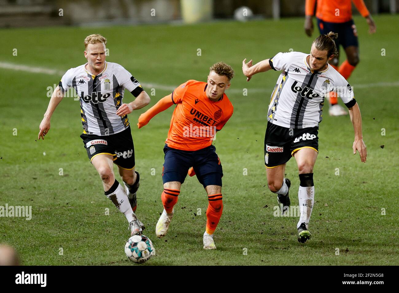 Charleroi's Jules Van Cleemput, Club's Noa Lang and Charleroi's Guillaume Gillet fight for the ball during a postponed soccer match between Sporting C Stock Photo